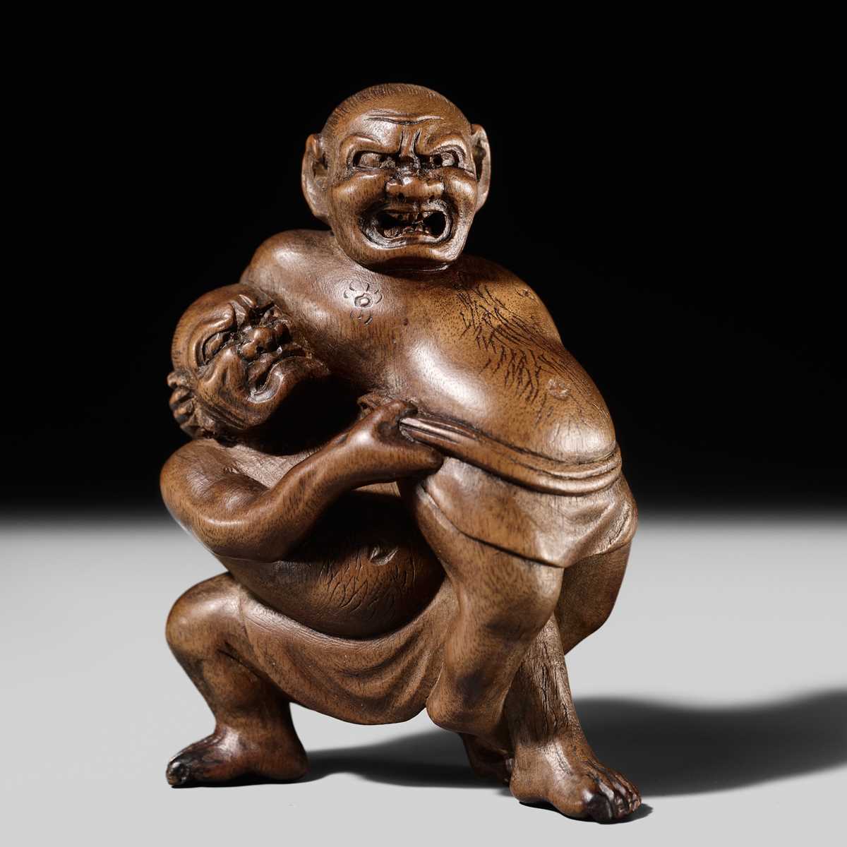 Lot 129 - MASAKAZU: A WOOD NETSUKE OF TWO SUMO WRESTLERS