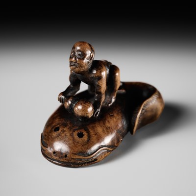 Lot 224 - ITTOKUSAI: A WOOD NETSUKE OF A BLIND FISHERMAN TAMING THE NAMAZU