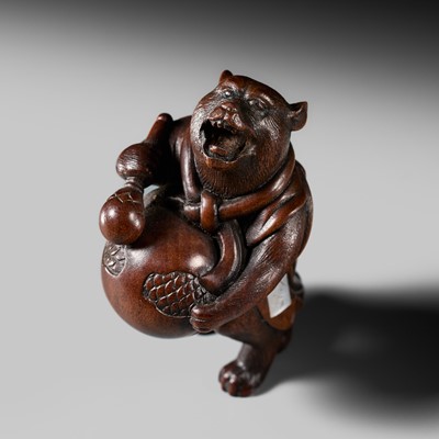 Lot 152 - MINKOKU: A FINE AND AMUSING WOOD NETSUKE OF TANUKI DISGUISED AS A PRIEST