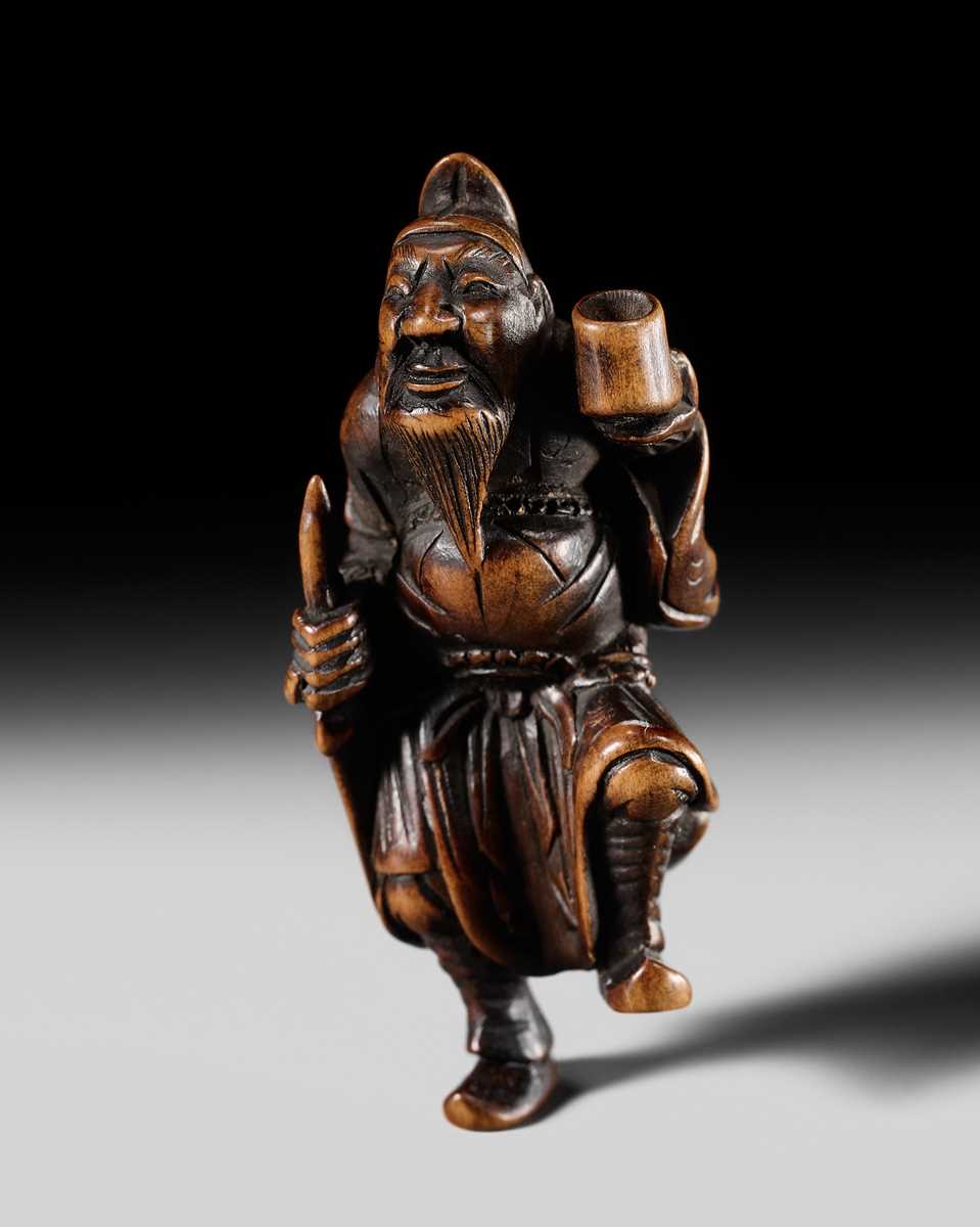 Lot 132 - HIDEMASA: A WOOD NETSUKE OF A CHORYO (ZHANG LIANG)