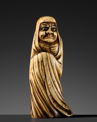 AN ANTLER NETSUKE OF DARUMA