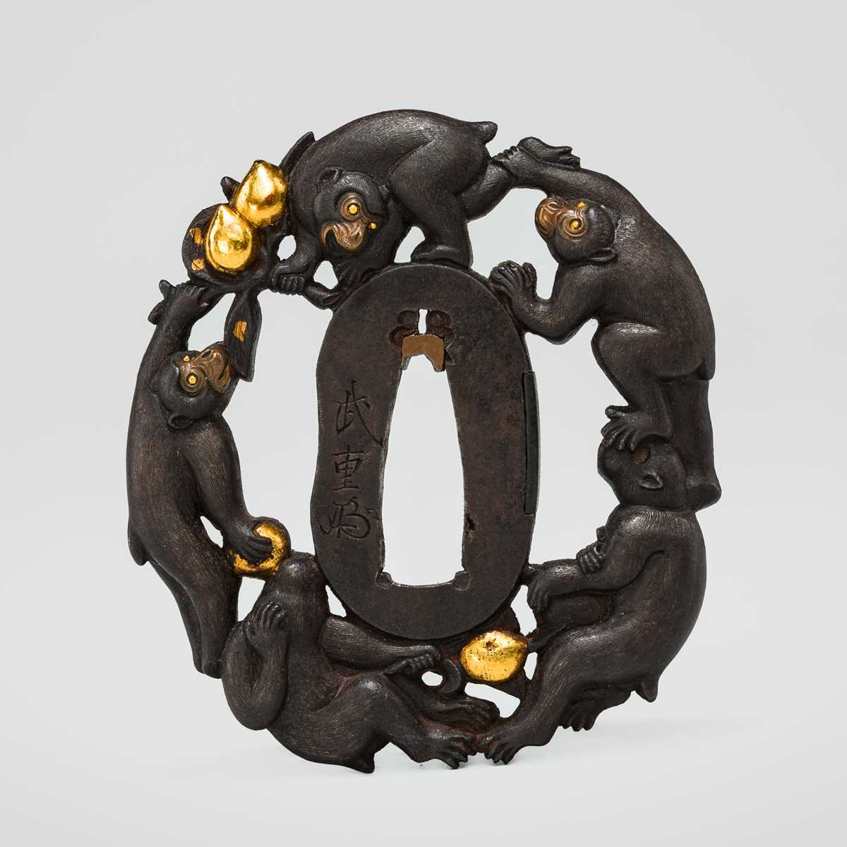Lot 63 - TAKESHIGE: AN IRON SUKASHI TSUBA WITH FIVE MONKEYS IN A PEACH TREE