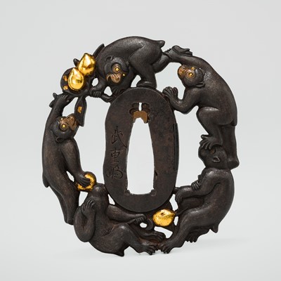 Lot 63 - TAKESHIGE: AN IRON SUKASHI TSUBA WITH FIVE MONKEYS IN A PEACH TREE