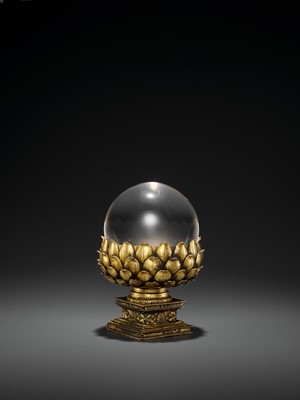 Lot 34 - A ROCK CRYSTAL SPHERE WITH A GILT BRONZE LOTUS BASE, QING DYNASTY