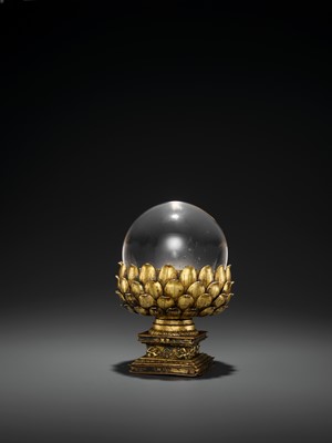 Lot 34 - A ROCK CRYSTAL SPHERE WITH A GILT BRONZE LOTUS BASE, QING DYNASTY