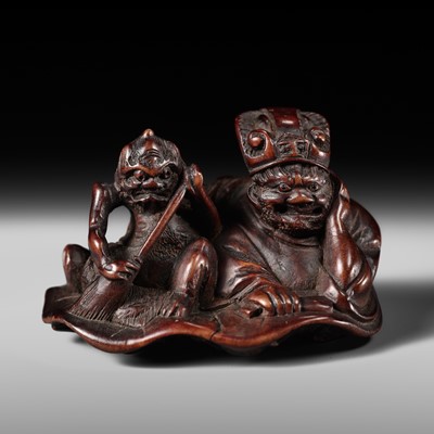 Lot 249 - A WOOD NETSUKE OF EMMA-O AND AN ONI ON A LOTUS LEAF
