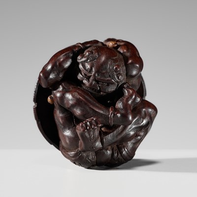 Lot 211 - A FINE NAGOYA SCHOOL WOOD NETSUKE OF A COWERING ONI DURING SETSUBUN