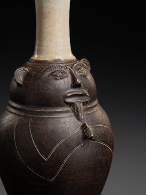 Lot 134 - A BROWN AND CELADON GLAZED ANTHROPOMORPHIC STONEWARE JAR, ANGKOR PERIOD