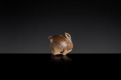Lot 127 - A SMALL BROWN GLAZED STONEWARE ‘HARE’ LIME POT, ANGKOR PERIOD