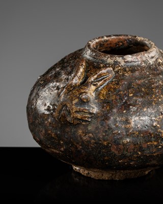 Lot 129 - A DARK BROWN GLAZED STONEWARE ‘RABBIT’ LIME POT, ANGKOR PERIOD