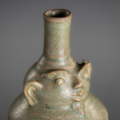 Lot 160 - A SAWANKHALOK CELADON GLAZED ANTHROPOMORPHIC STONEWARE EWER