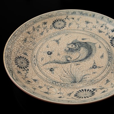 Lot 176 - AN ANNAMESE COBALT BLUE AND WHITE STONEWARE DISH WITH CARP AND TENDRILS