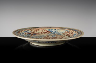 A THAI UNDERGLAZE BLUE AND IRON RED DECORATED STONEWARE DISH