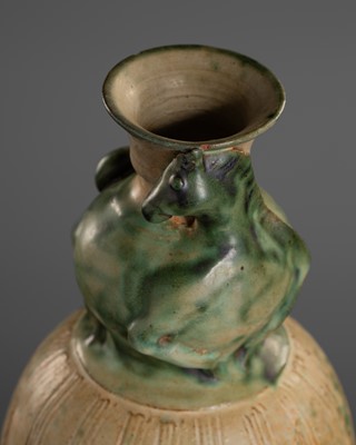 Lot 171 - A GREEN AND WHITE-GLAZED TERRACOTTA BOTTLE VASE WITH HORSE, MON TRIBE