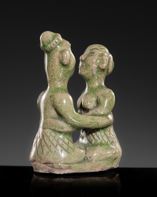 Lot 157 - A SAWANKHALOK GREEN-GLAZED STONEWARE FIGURINE OF AN EMBRACING COUPLE, 14TH-16TH CENTURY
