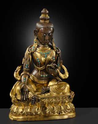 Lot 324 - A TURQUOISE-INLAID GILT-COPPER REPOUSSÉ FIGURE OF GREEN TARA, TIBETAN-CHINESE, EARLY 19TH CENTURY