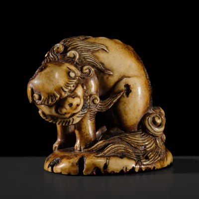 Lot 301 - AN IMPRESSIVE AND LARGE ANTLER SEAL NETSUKE OF A SHISHI