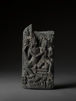 Lot 741 - AN INDIAN BLACK STONE STELE DEPICTING UMA-MAHESHVARA, PALA PERIOD