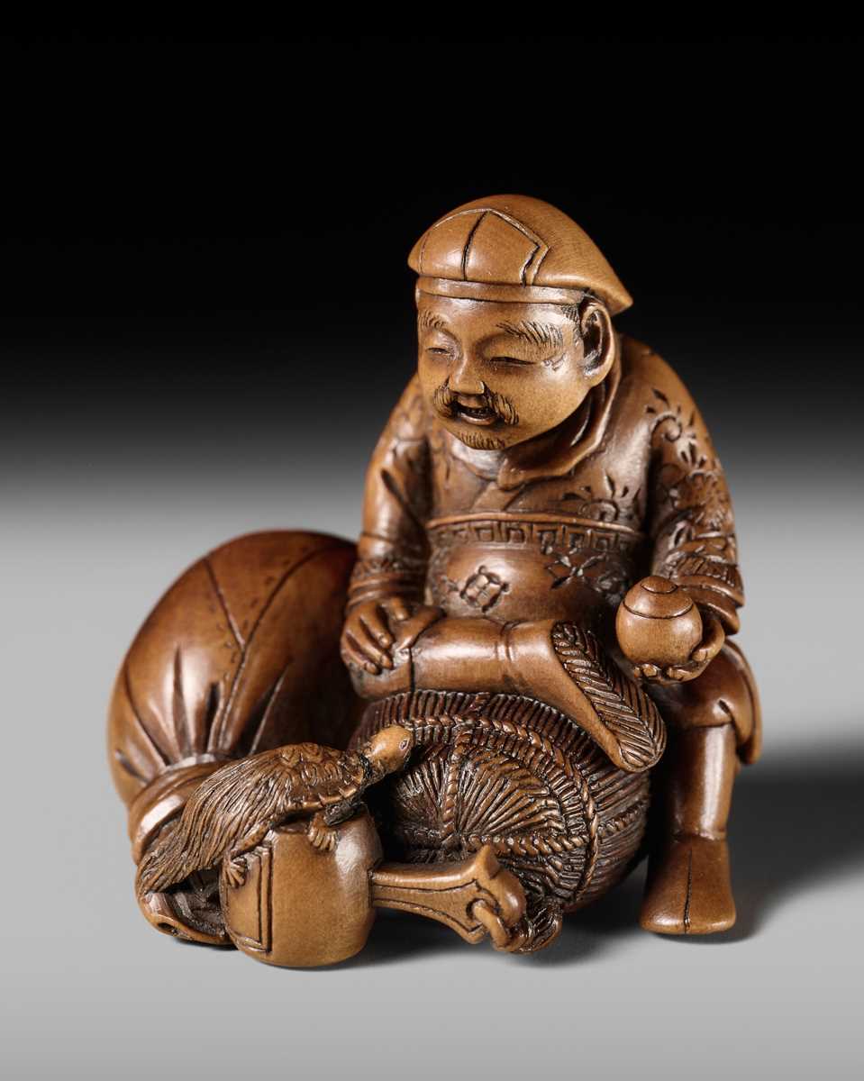Lot 268 - HOJITSU: A SUPERB WOOD NETSUKE OF DAIKOKU