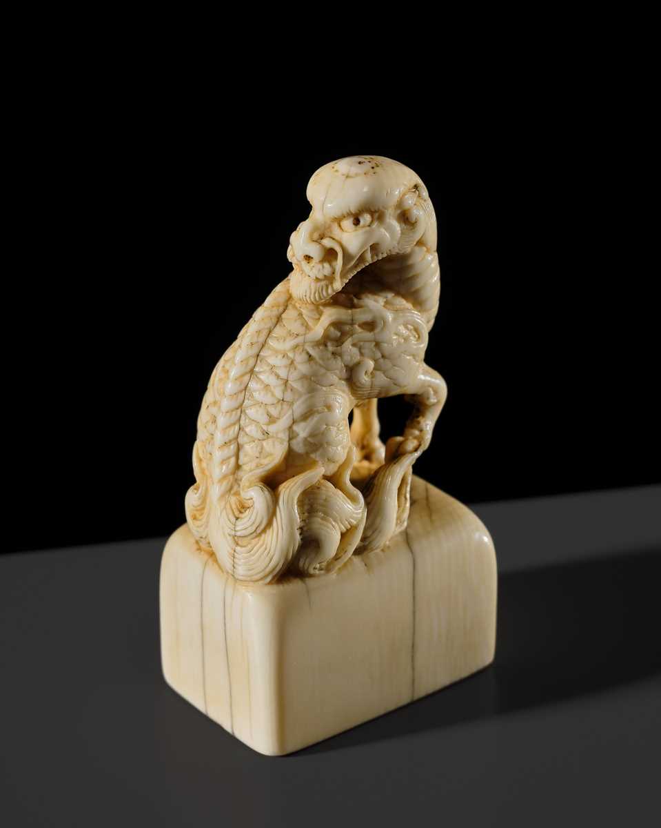 Lot 99 - MUNEHARU: A FINE KYOTO SCHOOL IVORY SEAL-TYPE (INGYO) NETSUKE OF A YOUNG KIRIN