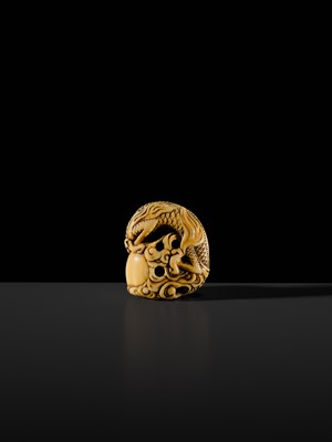 Lot 114 - A POWERFUL KYOTO SCHOOL IVORY NETSUKE OF A DRAGON AND TAMA PEARL