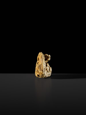Lot 114 - A POWERFUL KYOTO SCHOOL IVORY NETSUKE OF A DRAGON AND TAMA PEARL