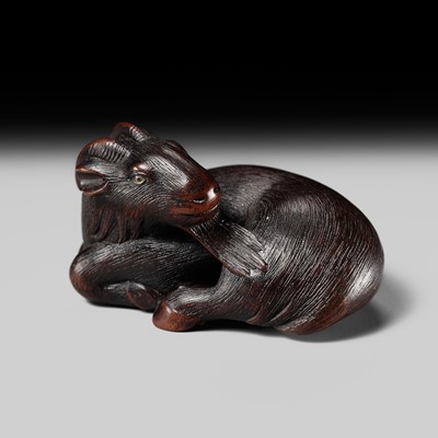 Lot 189 - YUKIKAZU: A SUPERB WOOD NETSUKE OF A RECUMBENT GOAT