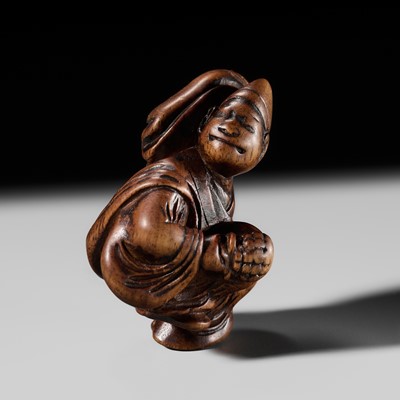 A FINE EDO SCHOOL WOOD NETSUKE OF A SAMBASO DANCER