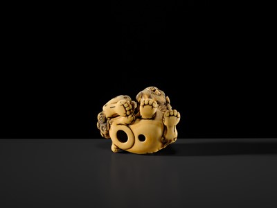 Lot 104 - A LARGE IVORY NETSUKE OF A SHISHI AND ITS YOUNG
