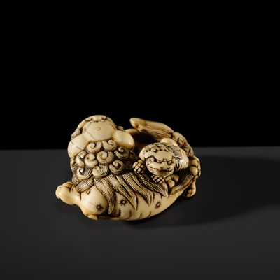 Lot 104 - A LARGE IVORY NETSUKE OF A SHISHI AND ITS YOUNG