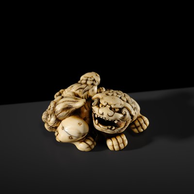 Lot 104 - A LARGE IVORY NETSUKE OF A SHISHI AND ITS YOUNG