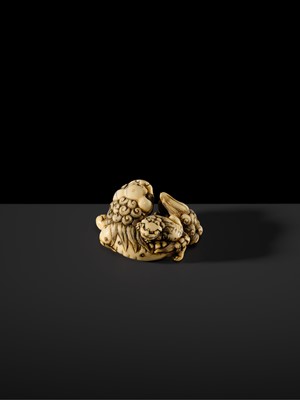 Lot 104 - A LARGE IVORY NETSUKE OF A SHISHI AND ITS YOUNG