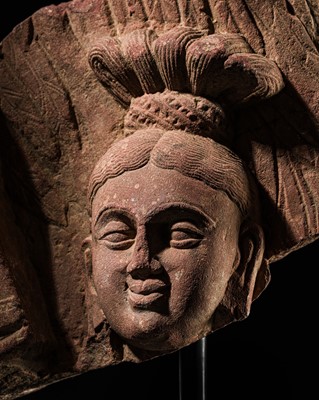 Lot 610 - A PINK SANDSTONE HEAD OF A YAKSHI, MATHURA, KUSHAN PERIOD, 2ND-3RD CENTURY AD