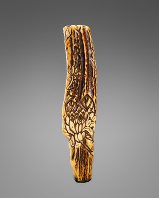 A LARGE ANTLER NETSUKE WITH CHRYSANTHEMUM