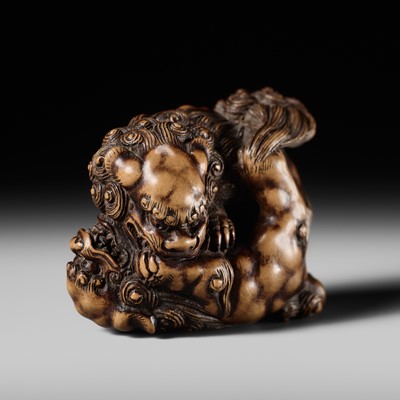 Lot 245 - TOMOYUKI: A LARGE AND POWERFUL WOOD NETSUKE OF TWO SHISHI