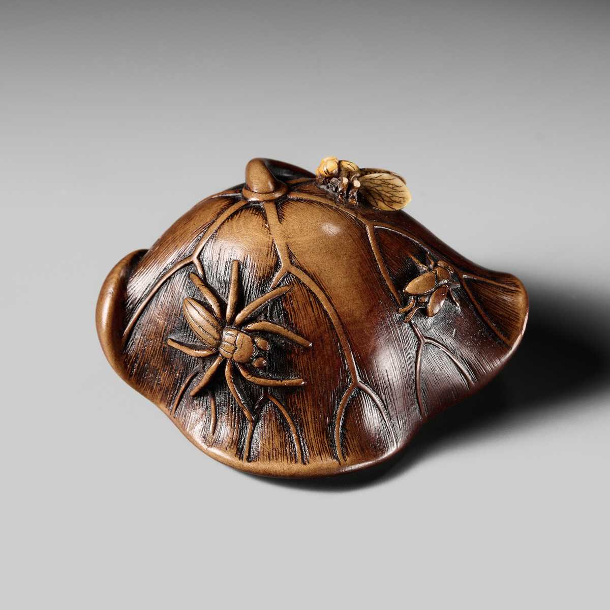 Lot 219 - A FINE WOOD AND IVORY NETSUKE OF A LOTUS