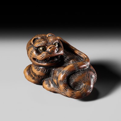 Lot 371 - KO BAAS: A WOOD NETSUKE OF A TIGER, AFTER TANAKA MINKO