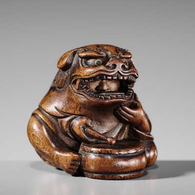 Lot 489 - ASATOSHI: A WOOD NETSUKE OF A KARAKO DRUMMER WITH SHISHIMAI MASK