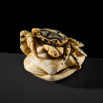 Lot 378 - MEIKAN SHOJI: A FINE IVORY NETSUKE OF A CRAB ON A CLAM