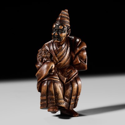SHURAKU: A GOOD WOOD NETSUKE OF A SAMBASO DANCER