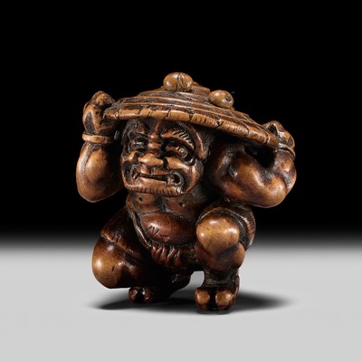 Lot 468 - A FINE YAMADA SCHOOL WOOD NETSUKE OF AN ONI DURING SETSUBUN