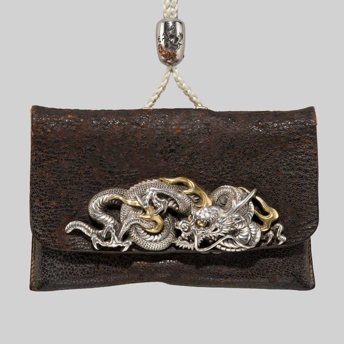Lot 61 - KIKUGAWA: A LEATHER TABAKO-IRE (POUCH) WITH A SUPERB DRAGON GOLD AND SILVER KANAMONO (POUCH CLASP)