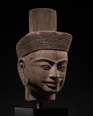 Lot 413 - AN IMPORTANT SANDSTONE HEAD OF SHIVA, KHMER EMPIRE, ANGKOR PERIOD, ANGKOR WAT STYLE, 13TH CENTURY
