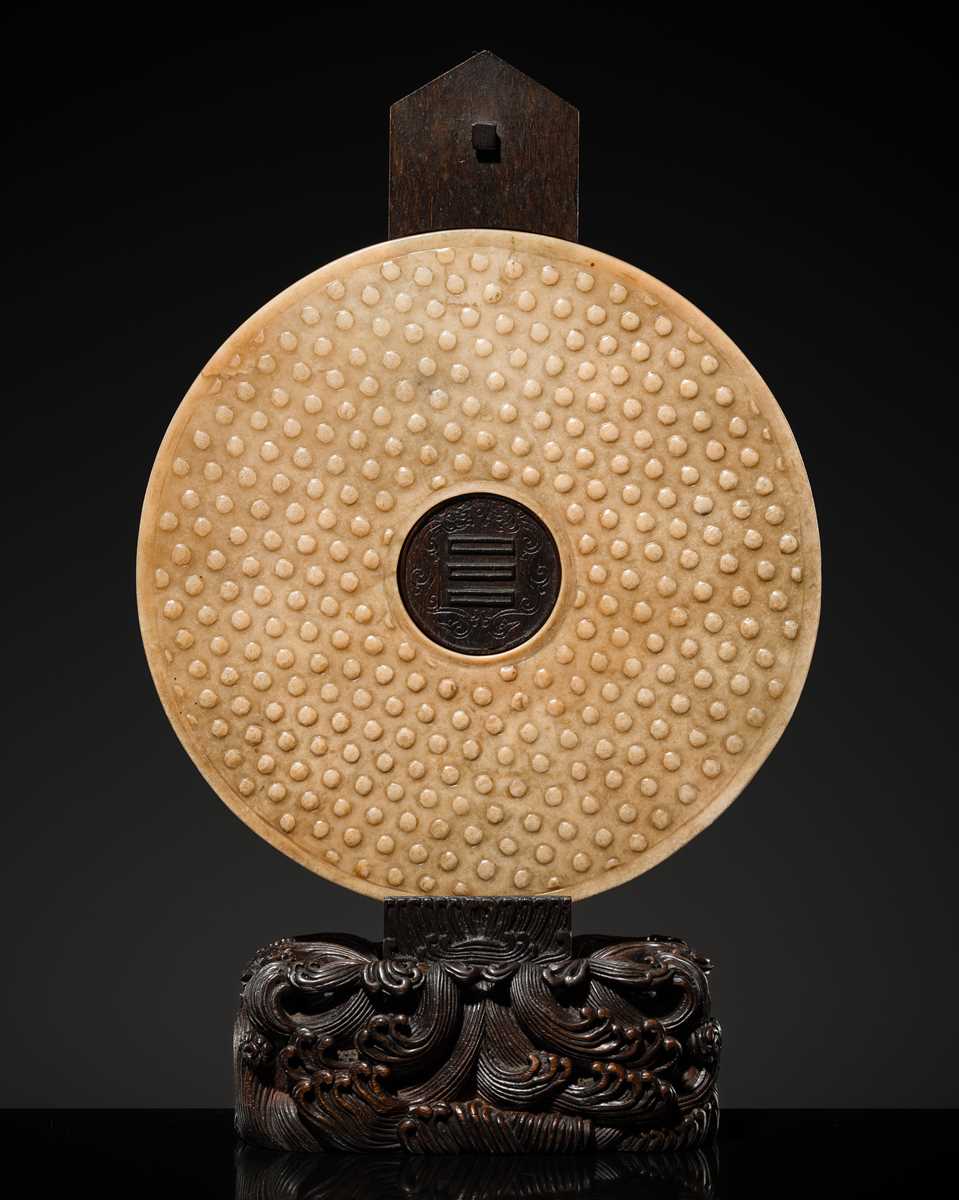 Lot 125 - A HIGHLY IMPORTANT ARCHAIC YELLOW JADE BI DISK, ON AN IMPERIALLY INSCRIBED ZITAN STAND, FROM THE PERSONAL COLLECTION OF THE QIANLONG EMPEROR (HONGLI)