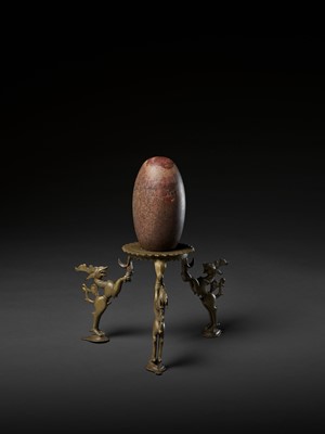 Lot 748 - AN INDIAN STONE BRAHMANDA, ‘COSMIC EGG’, AND MATCHING BRONZE TRIPOD STAND