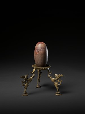 Lot 748 - AN INDIAN STONE BRAHMANDA, ‘COSMIC EGG’, AND MATCHING BRONZE TRIPOD STAND