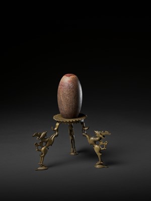 Lot 748 - AN INDIAN STONE BRAHMANDA, ‘COSMIC EGG’, AND MATCHING BRONZE TRIPOD STAND