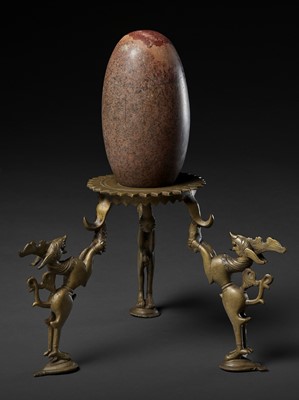 Lot 748 - AN INDIAN STONE BRAHMANDA, ‘COSMIC EGG’, AND MATCHING BRONZE TRIPOD STAND