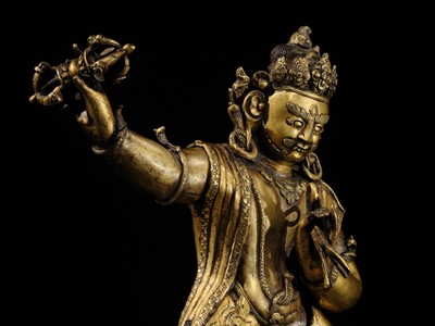 Lot 32 - A LARGE GILT-BRONZE FIGURE OF VAJRAPANI, TIBET, 16TH-17TH CENTURY