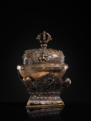 Lot 33 - A KAPALA (SKULL CUP) WITH SEPARATE COPPER ALLOY COVER AND STAND, TIBET, 18TH-19TH CENTURY